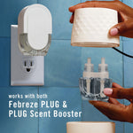 Hands assembling a Febreze PLUG warmer and refill bottle next to a plugged-in unit, showing compatibility with both devices.