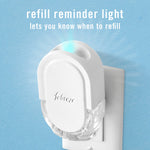 Febreze plug-in device mounted in an outlet with a glowing blue refill reminder light and text about the refill reminder