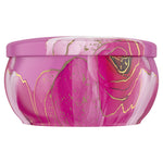 Side view of a decorative pink Febreze Romance & Desire candle tin showing floral marbled artwork wrapping the container