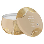 Close-up of Febreze Soothe & Restore candle tin and lid showing product name and 11 oz label on lid