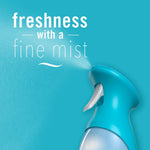 Close-up of a Febreze spray nozzle misting on a turquoise background with text 'freshness with a fine mist'.