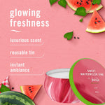 Styled product graphic showing Febreze Sweet Watermelon Vine tin candle with watermelon slices and text listing features like reusable tin