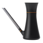Matte black Fiskars indoor watering can with translucent angled spout and orange trim, side view