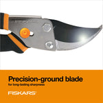 Close-up of Fiskars pruner blade and pivot showing precision-ground blade with orange Fiskars branding panel
