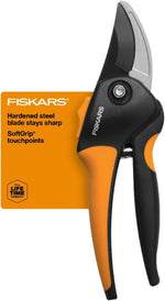 Close-up of Fiskars pruner packaging showing upper blade, pivot bolt, and orange SoftGrip handle with branded card