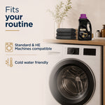 Woolite Darks Protect bottle on a laundry room counter above a front-load washer with text noting machine compatibility and cold-water friendly