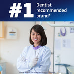 Smiling dentist in clinic with '#1 dentist recommended brand' headline above