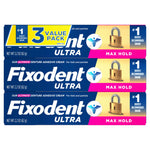 Three stacked Fixodent Ultra denture adhesive cream boxes showing 3-value pack and Max Hold branding