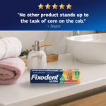 Fixodent Ultra tube and box displayed on a bathroom counter with customer quote above