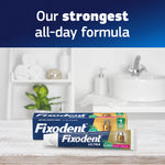 Fixodent Ultra tube and boxed packaging on a wooden surface with 'strongest all-day formula' text