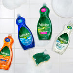 Flatlay of several Palmolive dish soap variants including the green Ultra Strength bottle and a soapy sponge