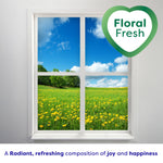 Window view over a field of yellow flowers with a heart-shaped badge reading Floral Fresh and a tagline below