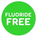 Green circular badge with bold white text reading 'FLUORIDE FREE' on a plain background