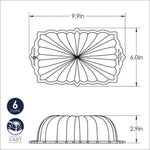 Technical line drawing with top and side views showing dimensions (9.9in by 6.0in by 2.9in) and fluted loaf pan profile