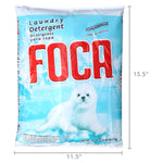 Single FOCA powder detergent bag photographed with dimension overlays showing 11.5 by 15.5 inches and front seal pup artwork.