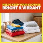 Folded colorful and white laundry stacked on a countertop beneath text that says helps keep your clothes bright & vibrant