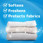 Stack of folded knit garments on a blue background with text claims: softens, freshens, protects fabrics.