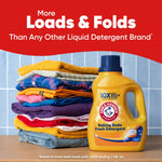 Stack of folded colorful clothes beside a yellow ARM & HAMMER detergent bottle under headline 'More Loads & Folds'.