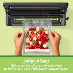 Hands holding a FoodSaver vacuum bag filled with cherry tomatoes being aligned into a vacuum sealer with 'Align to Seal' text below