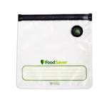 Clear FoodSaver vacuum zipper bag laid flat showing black zipper, round vacuum valve, logo and writable label area