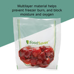 FoodSaver vacuum bag filled with strawberries with overlay text about multilayer material preventing freezer burn