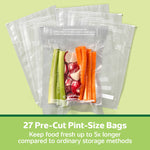 Stacked FoodSaver pre-cut pint vacuum bags with one sealed bag of vegetables centered on a pale green background