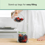 Person pouring berries into a standing FoodSaver Easy Fill vacuum bag on a kitchen counter