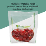 Clear FoodSaver vacuum bag filled with strawberries with text about multilayer material on a split green background
