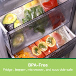 Refrigerator drawers stocked with FoodSaver vacuum-sealed bags holding avocados, herbs, fish, and produce