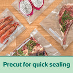 Several different foods including shrimp, steak, and produce sealed in precut FoodSaver vacuum bags arranged on a wooden surface.