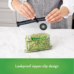Person sealing a FoodSaver reusable zipper bag with a black zipper clip while bag contains green split peas on countertop