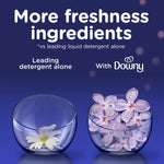 Two glass bowls illustrating fragrance comparison, one with a single flower and one filled with purple blossoms and text about freshness ingredients