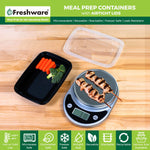 Open black meal prep container with clear lid on wooden surface, showing carrots and broccoli and a kitchen scale weighing a skewer