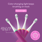 Four fuchsia electric toothbrush handles fanned out, each with a different colored light ring beneath the brush head and feature text on purple background.