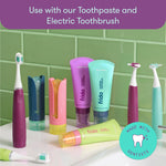 Bathroom-style display of Frida oral care products including electric toothbrushes, toothpaste tubes, and flosser heads on a counter.