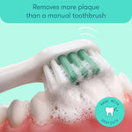 Close-up of toothbrush head brushing foamy toothpaste on dental model demonstrating plaque removal