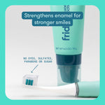 Frida toothpaste tube next to toothbrush with dab of gel and overlay text about strengthening enamel