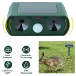 Front view close-up of green ultrasonic repeller with icons for solar power, ultrasonic tech and waterproof