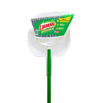 Front view of Libman broom head with green and gray bristles set inside a white dustpan