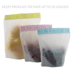 Three frosted stand-up snack bags with patterned tops, each containing different produce to show use.