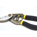 Detail view of the spring and handles on a G & F bypass pruner, showing textured grips and metal frame.