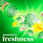 Dynamic graphic of a tilted Gain bottle pouring green scent beads and floral elements with sparkling droplets and 'powerful freshness' caption.