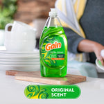 Gain Ultra Clean bottle staged on a cutting board in a kitchen setting with stacked plates nearby