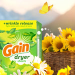 Close-up of a Gain dryer sheets box next to a basket of sunflowers and a yellow butterfly