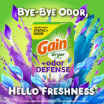 Promotional graphic of a Gain dryer sheets +odor defense box with colorful purple and blue leaf splashes and text 'Bye-Bye Odor, Hello Freshness'