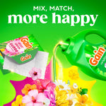 Promotional art of a Gain dryer sheet and a green liquid detergent bottle pouring scent over assorted flowers