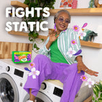 Person sitting on laundry machines with a box of Gain dryer sheets and text 'FIGHTS STATIC'