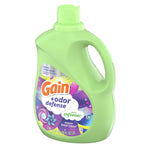 Angled view of a green Gain +odor defense fabric softener bottle with visible front label and handle