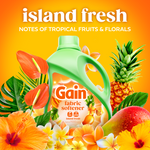 gain fabric softener island fresh bottle with tropical fruits and flowers on an orange background