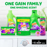 Product family arrangement showing multiple Gain Moonlight Breeze laundry products including a Gain flings! pouch on a laundry surface